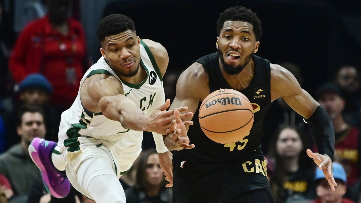Milwaukee Bucks forward Giannis Antetokounmpo (34) and Cleveland Cavaliers guard Donovan Mitchell (45) go for a loose ball during the first half at Rocket Mortgage FieldHouse