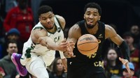 Milwaukee Bucks forward Giannis Antetokounmpo (34) and Cleveland Cavaliers guard Donovan Mitchell (45) go for a loose ball during the first half at Rocket Mortgage FieldHouse