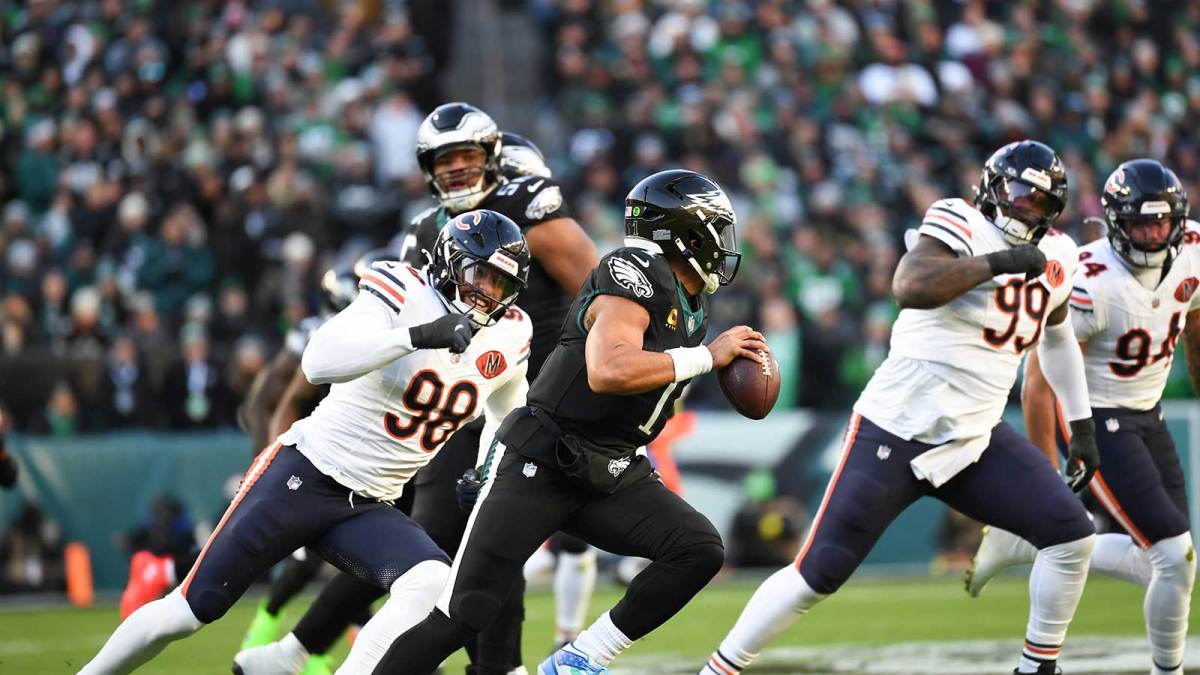 Philadelphia Eagles quarterback Jalen Hurts (1) scrambles with the ball defended by Chicago Bears defensive end Montez Sweat (98) during the first quarter of the game at Lincoln Financial Field.
