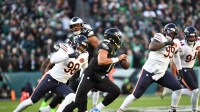 Philadelphia Eagles quarterback Jalen Hurts (1) scrambles with the ball defended by Chicago Bears defensive end Montez Sweat (98) during the first quarter of the game at Lincoln Financial Field.