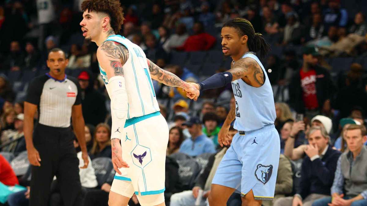 Memphis Grizzlies guard Ja Morant (right) holds the hand of Charlotte Hornets guard LaMelo Ball (left) during the fourth quarter at FedExForum.