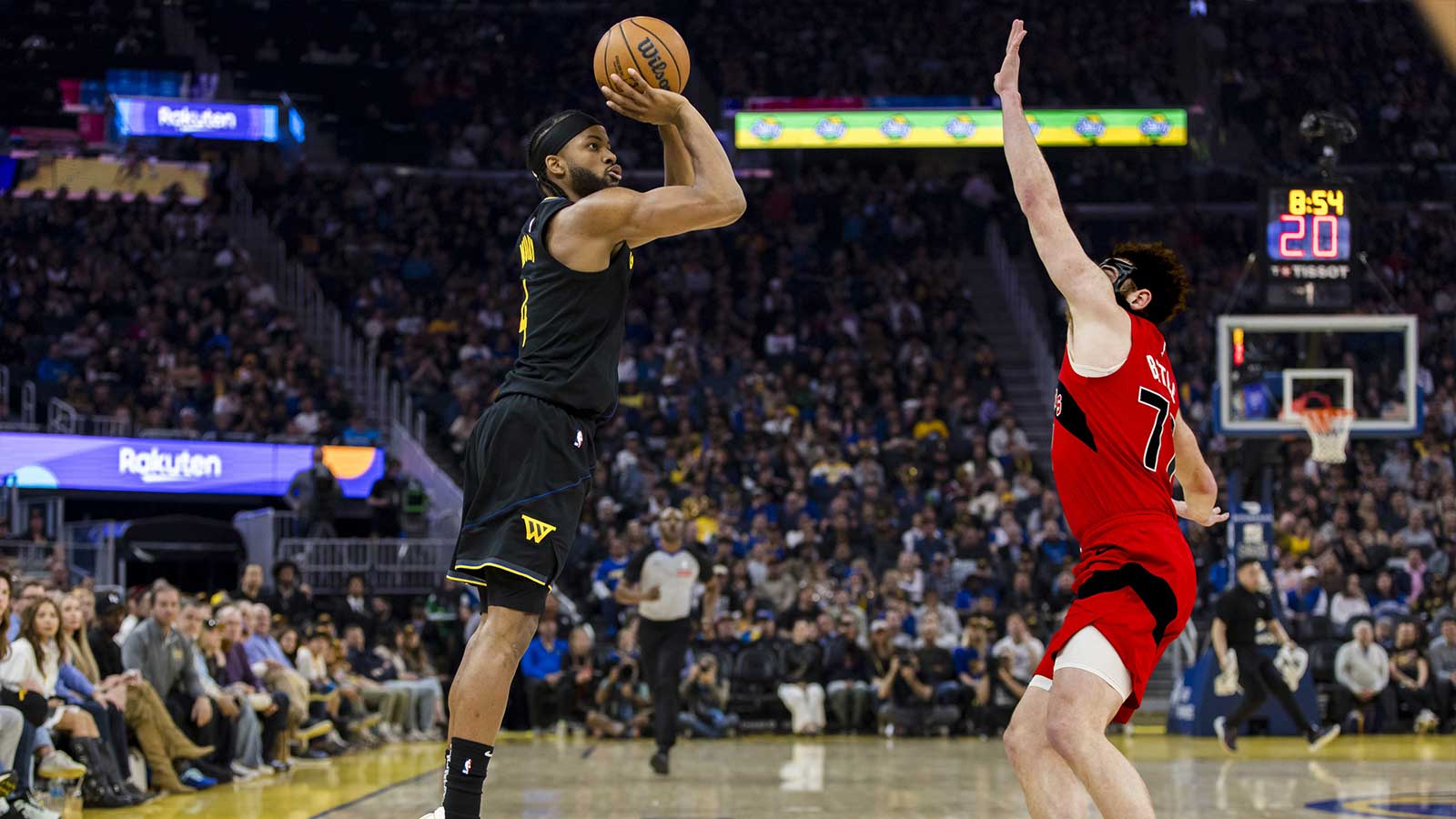 Golden State Warriors guard Moses Moody (4) takes a three-point shot as Toronto Raptors forward Jamison Battle (77) defends during the second quarter at Chase Center. 