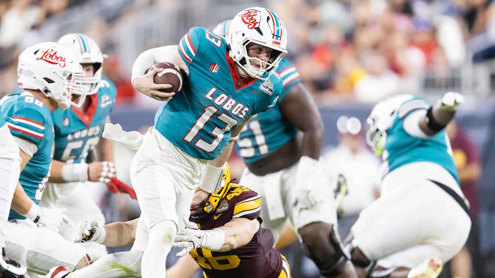New Mexico Lobos quarterback James Laubstein (13) against the Minnesota Gophers during the first half of the Rate Bowl at Chase Field.