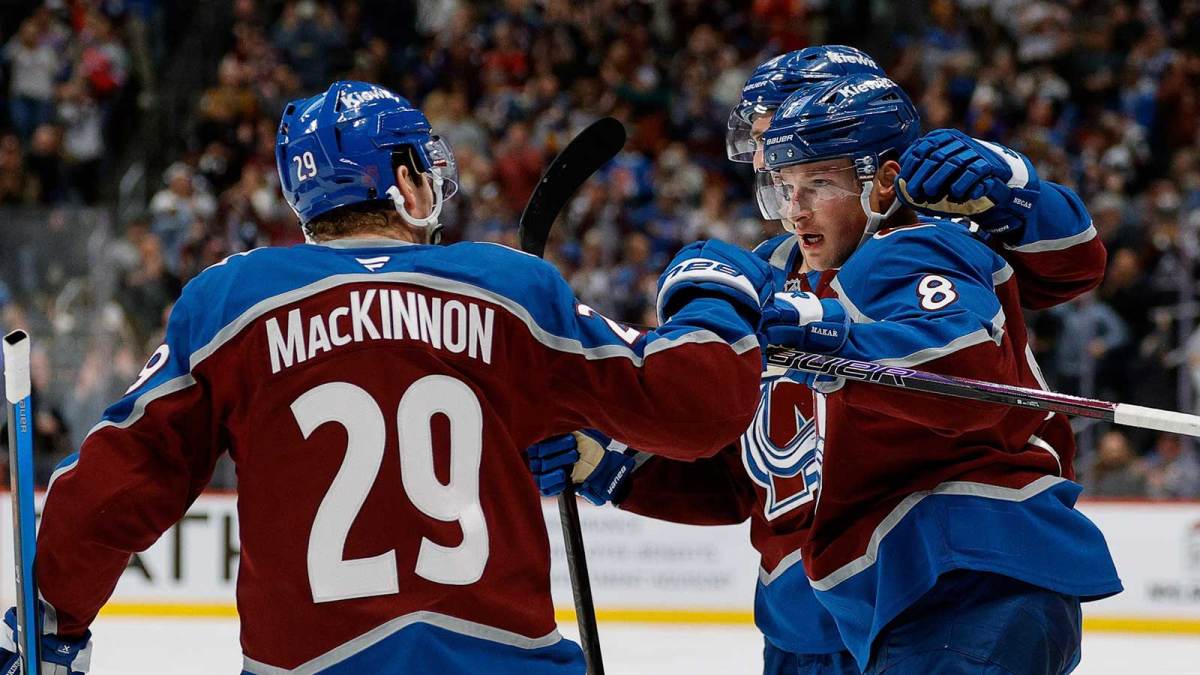 Colorado Avalanche defenseman Cale Makar (8) celebrates his goal with center Martin Necas (88) and center Nathan MacKinnon (29) in the second period against the New York Rangers at Ball Arena. M