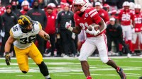 Nebraska Cornhuskers running back Emmett Johnson (21) runs against Iowa Hawkeyes linebacker Jayden Montgomery (36) during the first quarter at Memorial Stadium