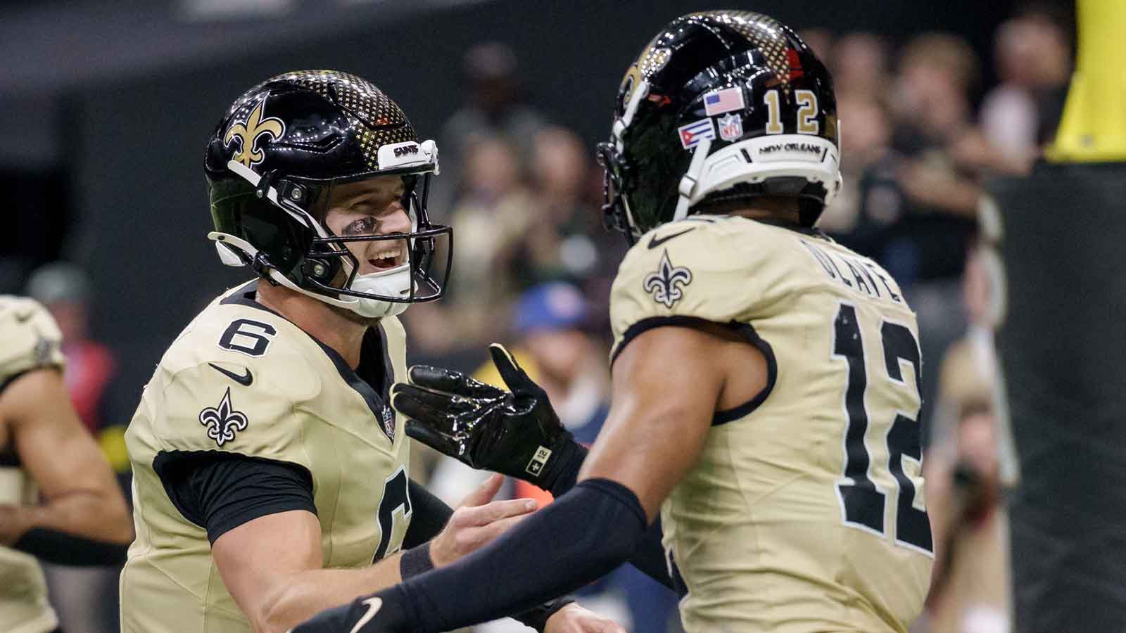 New Orleans Saints wide receiver Chris Olave (12) celebrates a touchdown against the New York Jets with New Orleans Saints quarterback Tyler Shough (6) during the third quarter at Caesars Superdome.