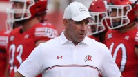 Utah Utes defensive coordinator Morgan Scalley watches the team warm up before a game against the Cal Poly Mustangs at Rice-Eccles Stadium.