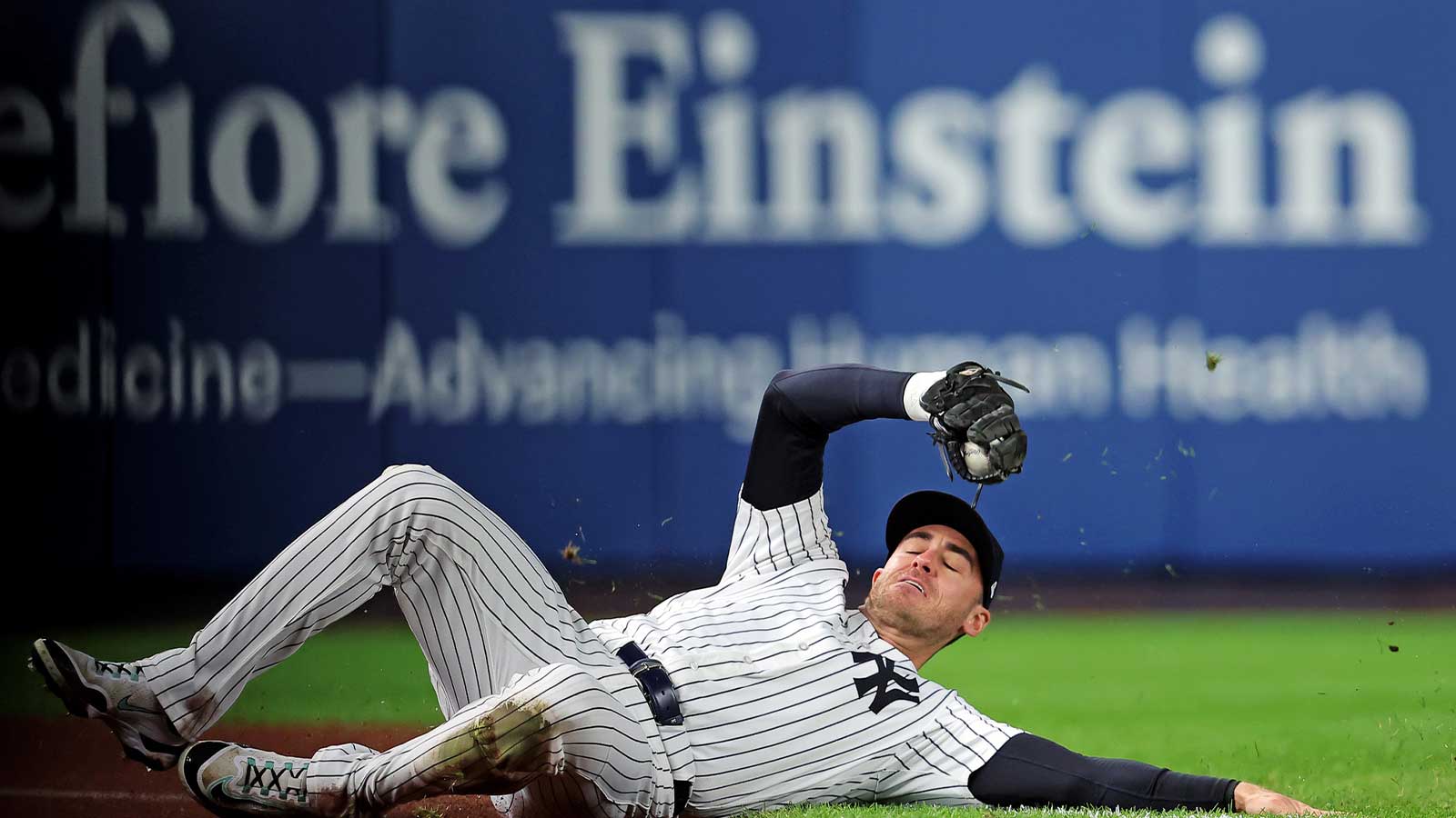 New York Yankees left fielder Cody Bellinger (35) slides to makes a catch during the first inning against the Toronto Blue Jays during game four of the ALDS round for the 2025 MLB playoffs at Yankee Stadium. Mandatory Credit: Brad Penner-Imagn Images