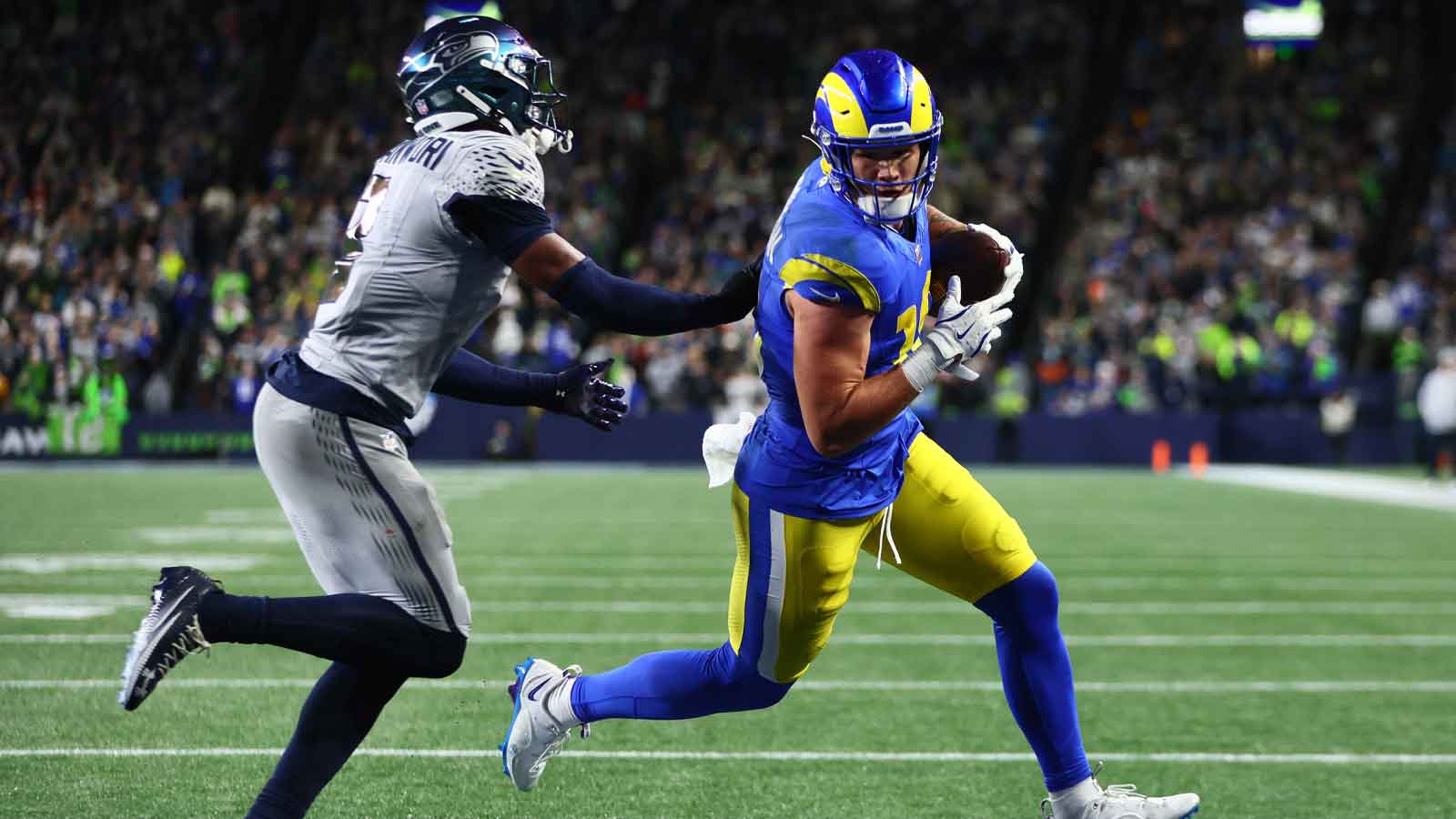 Los Angeles Rams tight end Terrance Ferguson (18) runs to score a touchdown against Seattle Seahawks safety Nick Emmanwori (3) in the first half at Lumen Field. 