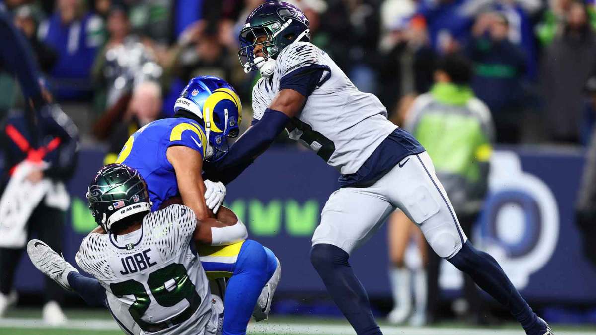 Dec 18, 2025; Seattle, Washington, USA; Seattle Seahawks cornerback Josh Jobe (29) and safety Nick Emmanwori (3) tackle Los Angeles Rams wide receiver Puka Nacua (12) in the first half at Lumen Field.
