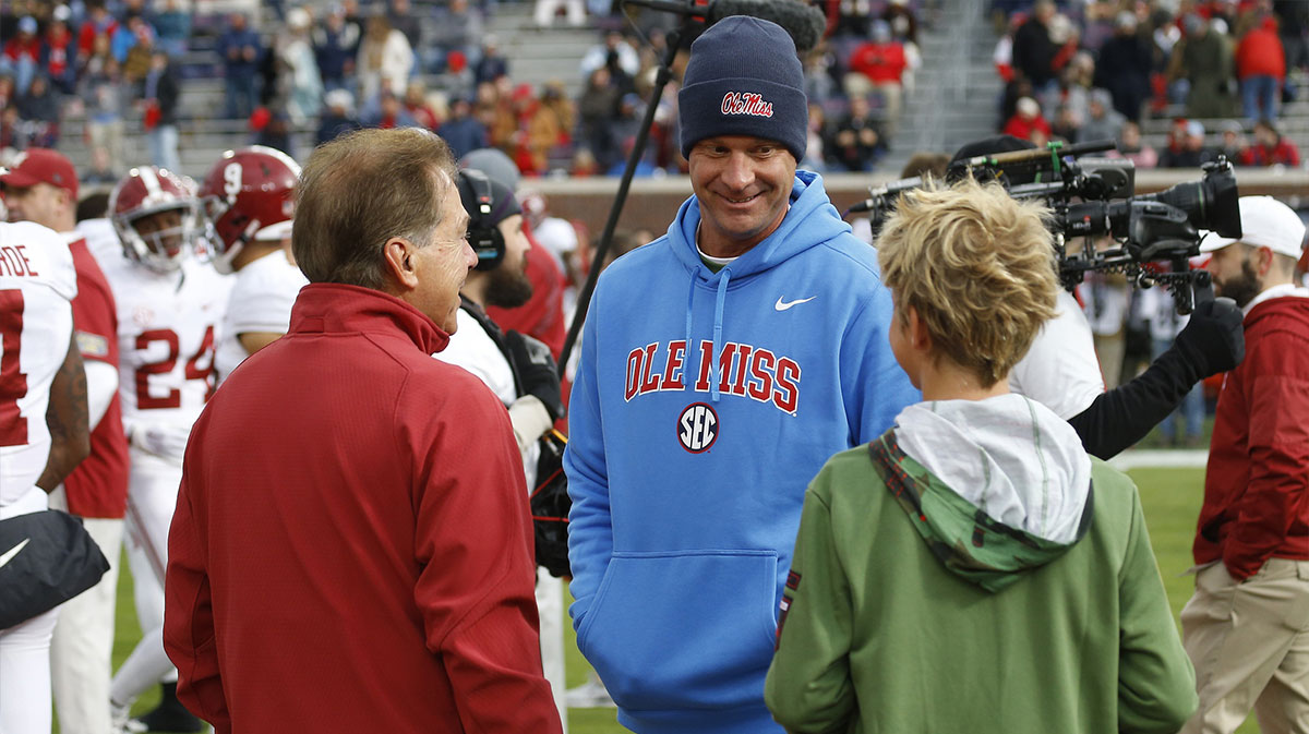 Alabama Crimson Tide head coach Nick Saban (left) and Mississippi Rebels head coach Lane Kiffin (middle) and Knox Kiffen talk prior to the game at Vaught-Hemingway Stadium.