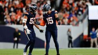 Denver Broncos linebacker Nik Bonitto (15) celebrates with Denver Broncos linebacker Jonah Elliss (52) after sacking Cincinnati Bengals quarterback Jake Browning (6) (not pictured) during the third quarter at Empower Field at Mile High.