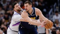 Denver Nuggets center Nikola Jokic (15) controls the ball under pressure from Utah Jazz center Jusuf Nurkic (30) in the first quarter at Ball Arena.