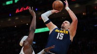 Denver Nuggets center Nikola Jokic (15) shoots the basketball over Miami Heat center Bam Adebayo (13) during the first quarter at Kaseya Center.