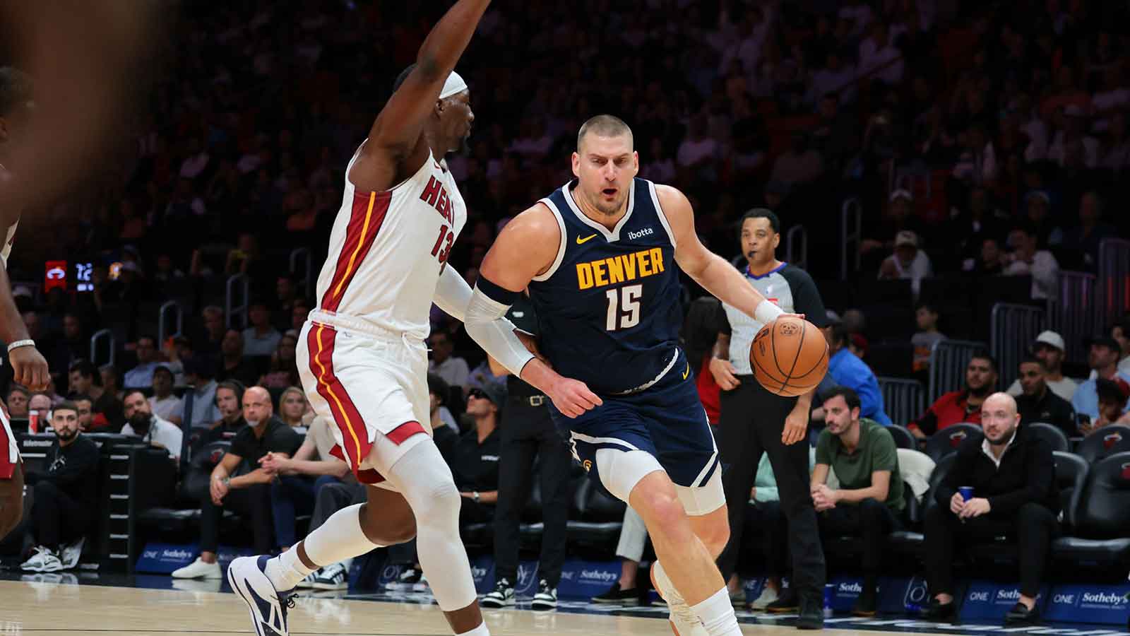 Denver Nuggets center Nikola Jokic (15) drives to the basket against Miami Heat center Bam Adebayo (13) during the first quarter at Kaseya Center.