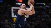 Denver Nuggets center Nikola Jokic (15) lines up a shot in the first quarter against the Orlando Magic at Ball Arena.
