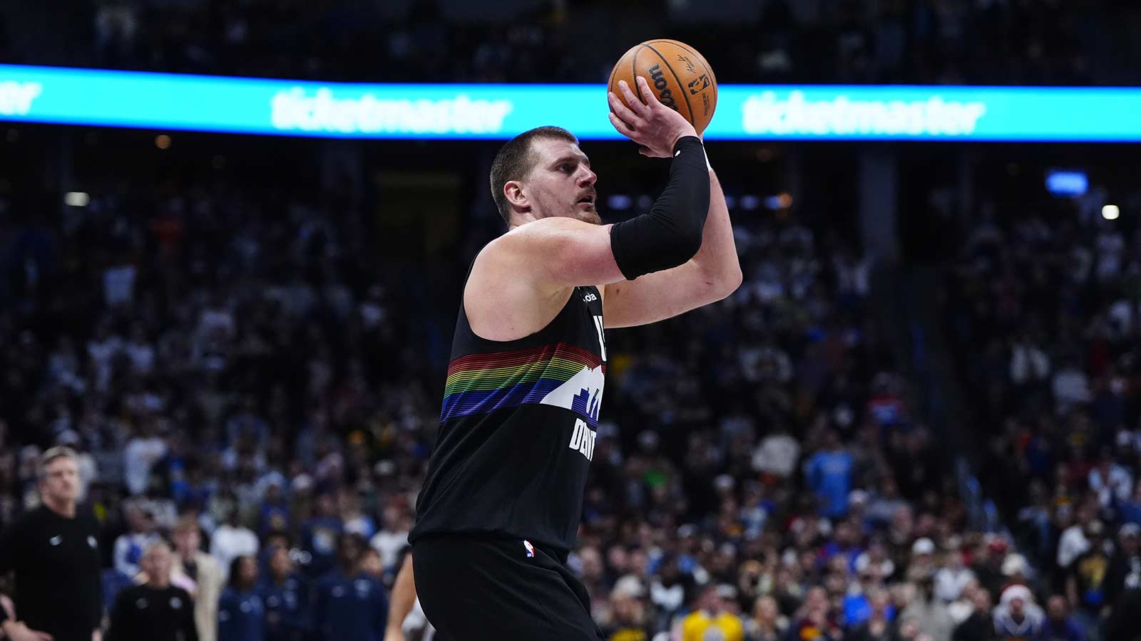 Denver Nuggets center Nikola Jokic (15) lines up a successful three point basket in overtime against the Minnesota Timberwolves at Ball Arena.