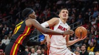 Miami Heat forward Nikola Jovic (5) runs towards the basket for a layup against Atlanta Hawks forward Onyeka Okongwu (17) during the first quarter at State Farm Arena.