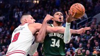 Milwaukee Bucks forward Giannis Antetokounmpo (34) is fouled by Chicago Bulls center Nikola Vucevic (9) in the fourth quarter at Fiserv Forum.
