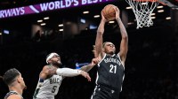 Dec 14, 2025; Brooklyn, New York, USA; Brooklyn Nets forward/center Noah Clowney (21) shoots the ball defended by Milwaukee Bucks guard Gary Trent Jr. (5) during the second half at Barclays Center. Mandatory Credit: John Jones-Imagn Images