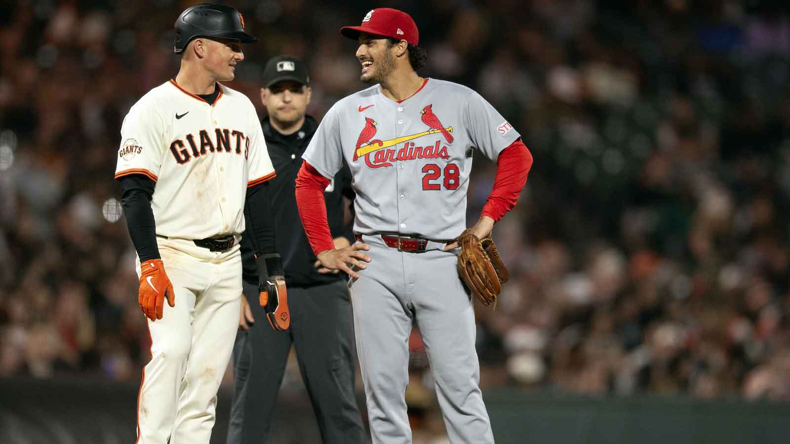 San Francisco Giants third baseman Matt Chapman (26) chats with St. Louis Cardinals third baseman Nolan Arenado (28) during the fourth inning at Oracle Park.