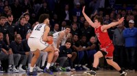 Duke Blue Devils forward Cameron Boozer (12) looks to shoot the ball against Texas Tech Red Raiders guard Nolan Groves (8) during the second half at Madison Square Garden.