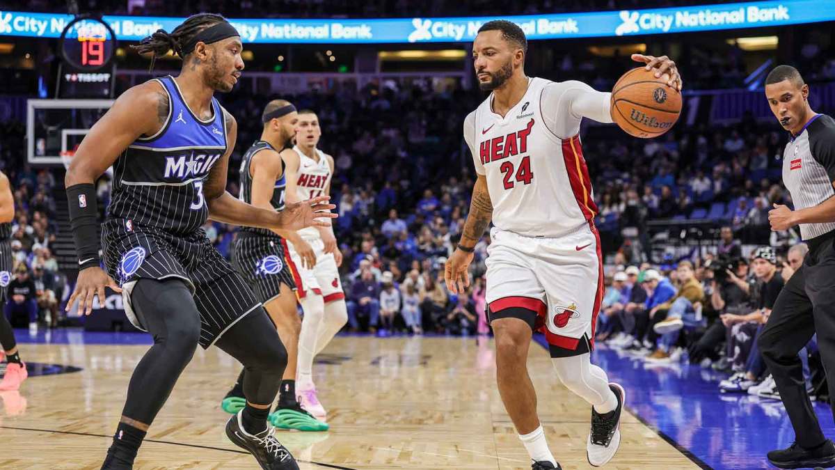 Miami Heat guard Norman Powell (24) handles the ball in front of Orlando Magic center Wendell Carter Jr. (34) during the first quarter at Kia Center. Mandatory Credit: Mike Watters-Imagn Images