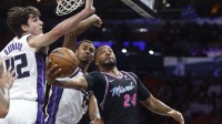 Miami Heat guard Norman Powell (24) shoots between Sacramento Kings center Maxime Raynaud (42) and forward Keegan Murray (13) during the first half at Kaseya Center.