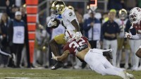Notre Dame Fighting Irish running back Jeremiyah Love (4) attempts to run past Stanford Cardinal safety Mitch Leigber (32) during the first quarter at Stanford Stadium.