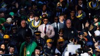 Notre Dame head coach Marcus Freeman, center, walks into Notre Dame Stadium with his players before a NCAA football game against Syracuse.
