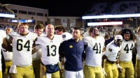 Notre Dame Fighting Irish head coach Marcus Freeman, offensive lineman Joe Otting (64), safety Adon Shuler (8), defensive lineman Junior Tuihalamaka (44), quarterback CJ Carr (13) and defensive lineman Donovan Hinish (41) after the game against the Boston College Eagles at Alumni Stadium.