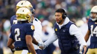 Notre Dame head coach Marcus Freeman celebrates after a touchdown in the first half of a NCAA football game against Syracuse.