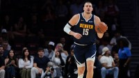 Denver Nuggets center Nikola Jokic (15) dribbles the basketball against the Miami Heat during the first quarter at Kaseya Center.
