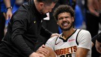 A Denver Nuggets trainer checks on forward Cameron Johnson (23) during the second half against the Dallas Mavericks at the American Airlines Center.