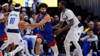 Denver Nuggets guard Jamal Murray (27) controls the ball under pressure from Dallas Mavericks forward Naji Marshall (13) in the third quarter at Ball Arena.