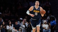 Denver Nuggets center Nikola Jokic (15) dribbles the basketball against the Miami Heat during the first quarter at Kaseya Center.