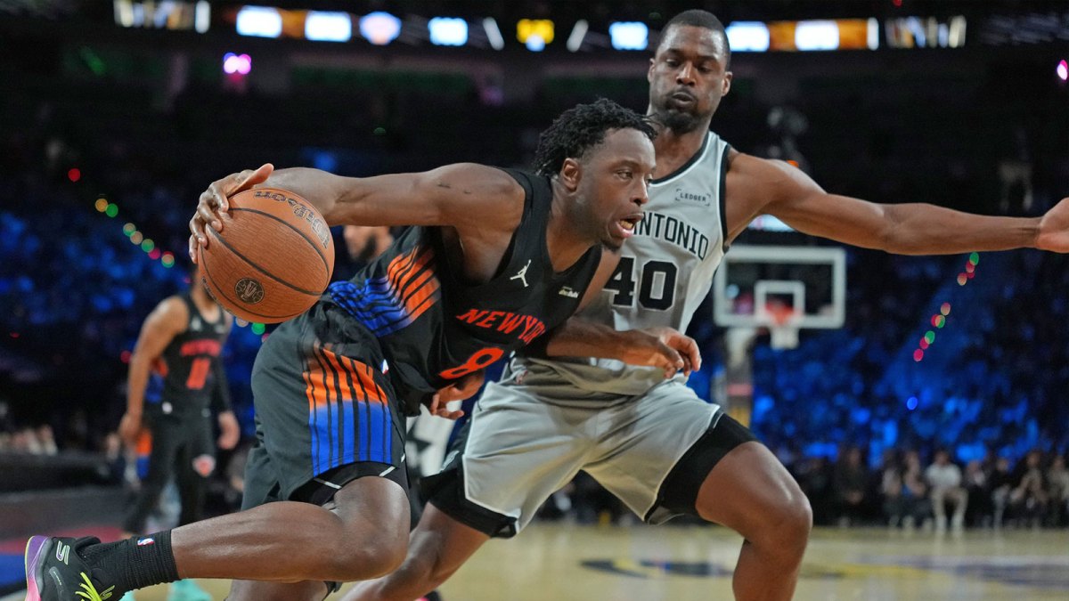 Dec 16, 2025; Las Vegas, Nevada, USA; New York Knicks forward Og Anunoby (8) dribbles the ball past San Antonio Spurs forward Harrison Barnes (40) in the second half during the Emirates NBA Cup Final at T-Mobile Arena.