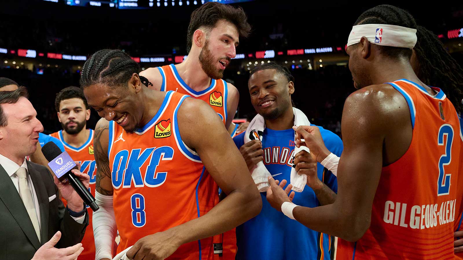 Oklahoma City Thunder guard Jalen Williams (8) laughs during a post-game interview with teammates after a game against the Portland Trail Blazers at Moda Center. 