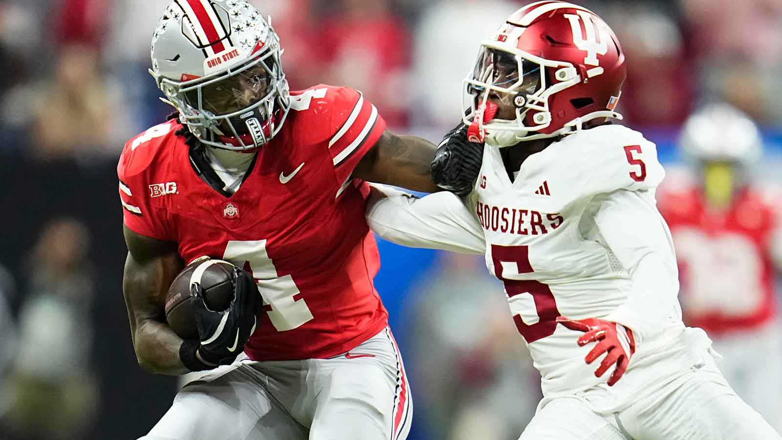 Ohio State Buckeyes wide receiver Jeremiah Smith (4) shakes off Indiana Hoosiers defensive back D'Angelo Ponds (5) during the Big Ten Conference championship game at Lucas Oil Stadium in Indianapolis on Dec. 6, 2025. Ohio State lost 13-10.