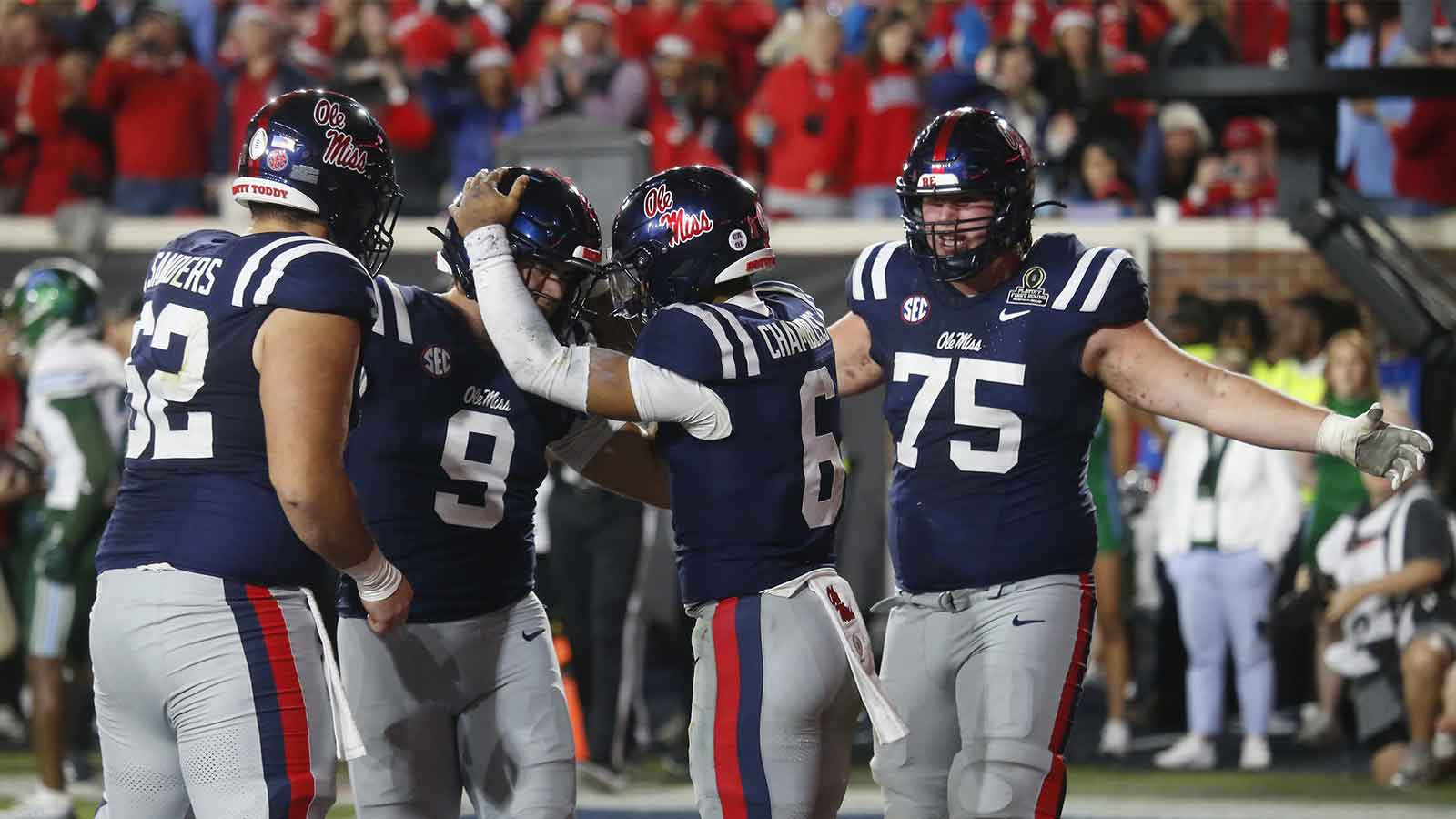 Mississippi Rebels quarterback Trinidad Chambliss (6) reacts with teammates after scoring a touchdown against the Tulane Green Wave during the second half of a game at Vaught-Hemingway Stadium.