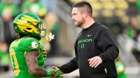Oregon Ducks head coach Dan Lanning greets Oregon Ducks running back Jordon Davison (0) before the game against the James Madison Dukes at Autzen Stadium.