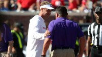 Mississippi Rebels head coach Lane Kiffin and LSU Tigers head coach Ed Orgeron talk prior to their game at Vaught-Hemingway Stadium.