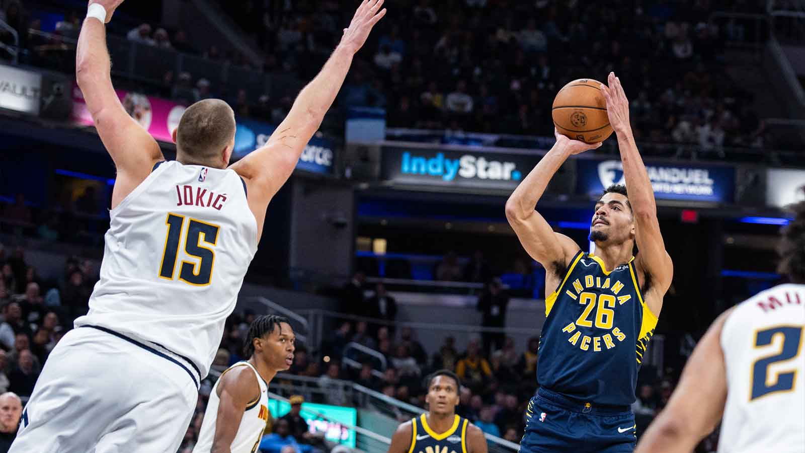 Indiana Pacers guard Ben Sheppard (26) shoots the ball while Denver Nuggets center Nikola Jokic (15) defends in the second half at Gainbridge Fieldhouse. 