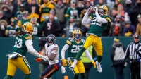Green Bay Packers safety Xavier McKinney (29) soars high to intercept a pass against the Chicago Bears in the third quarter on Sunday, Jan. 5, 2025, at Lambeau Field in Green Bay, Wis. It was McKinney's career-high eighth interception of the season.