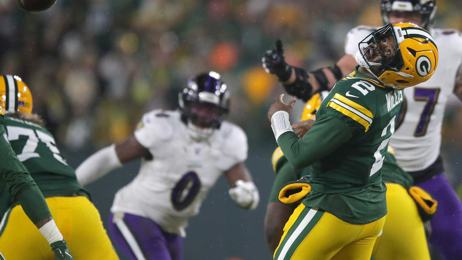 Green Bay Packers quarterback Malik Willis (2) is hit in the head by the snap, leading to a fumble against the Baltimore Ravens on Saturday, December 27, 2025, at Lambeau Field in Green Bay, Wis. The Ravens defeated the Packers 41-24.