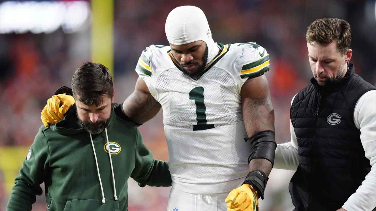 Green Bay Packers defensive end Micah Parsons (1) walks off the field with help from medical personnel following an injury during the third quarter against the Denver Broncos at Empower Field at Mile High.