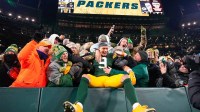 Green Bay Packers wide receiver Christian Watson (9) celebrates with fans after defeating the Chicago Bears at Lambeau Field.
