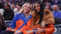 WNBA players Paige Bueckers (l) and Angel Reese (r) sit courtside during the game between the Orlando Magic and the New York Knicks at Madison Square Garden.