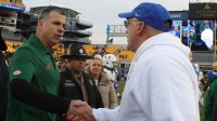 Miami Hurricanes head coach Mario Cristobal (left) and Pittsburgh Panthers college football head coach Pat Narduzzi (right) shake hands after their game at Acrisure Stadium.
