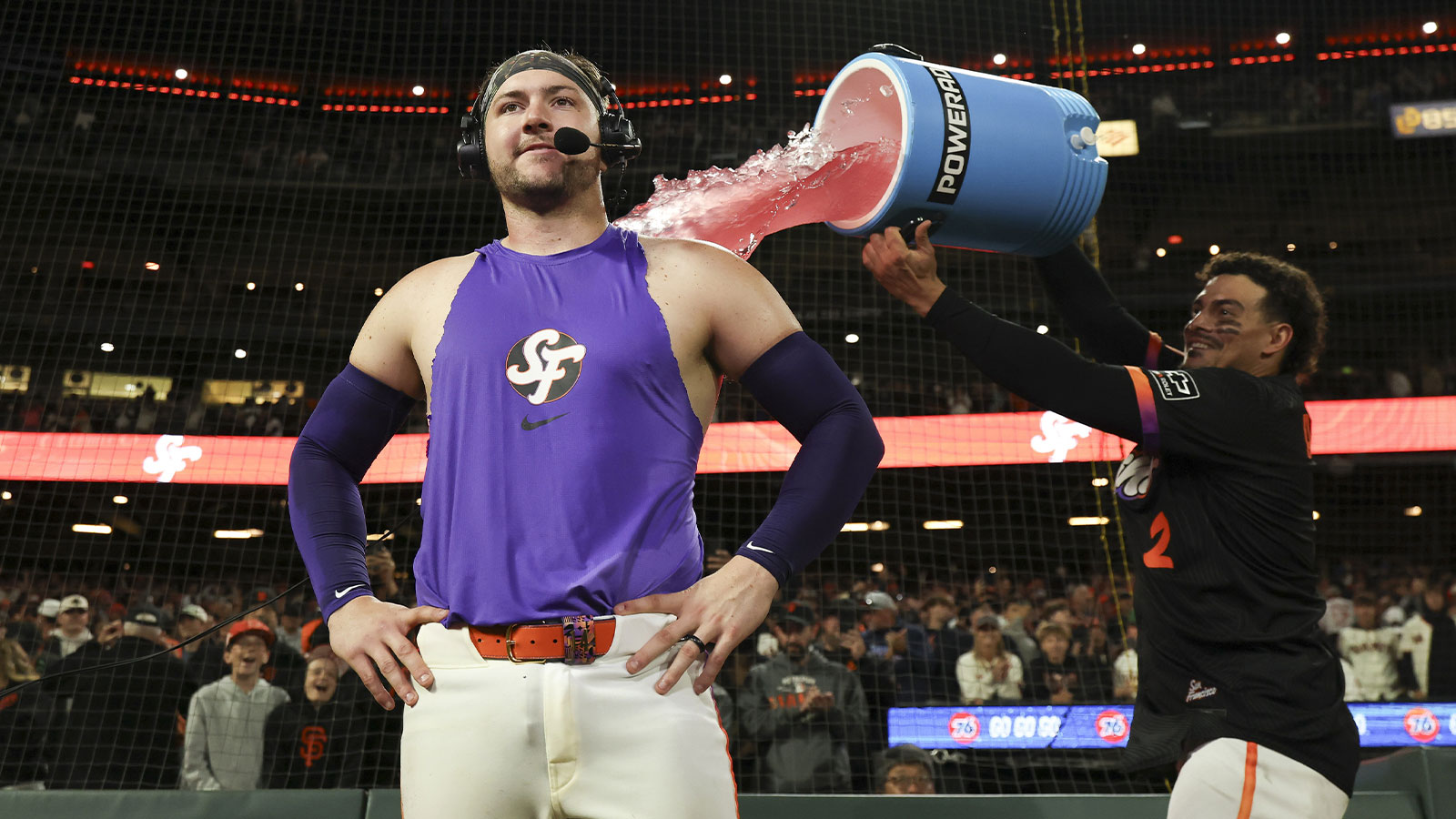 San Francisco Giants shortstop Willy Adames (2) dumps powerade on catcher Patrick Bailey (14) as Bailey is interviewed after hitting a three-run home run during the ninth inning for a walk-off win against the Philadelphia Phillies at Oracle Park. 